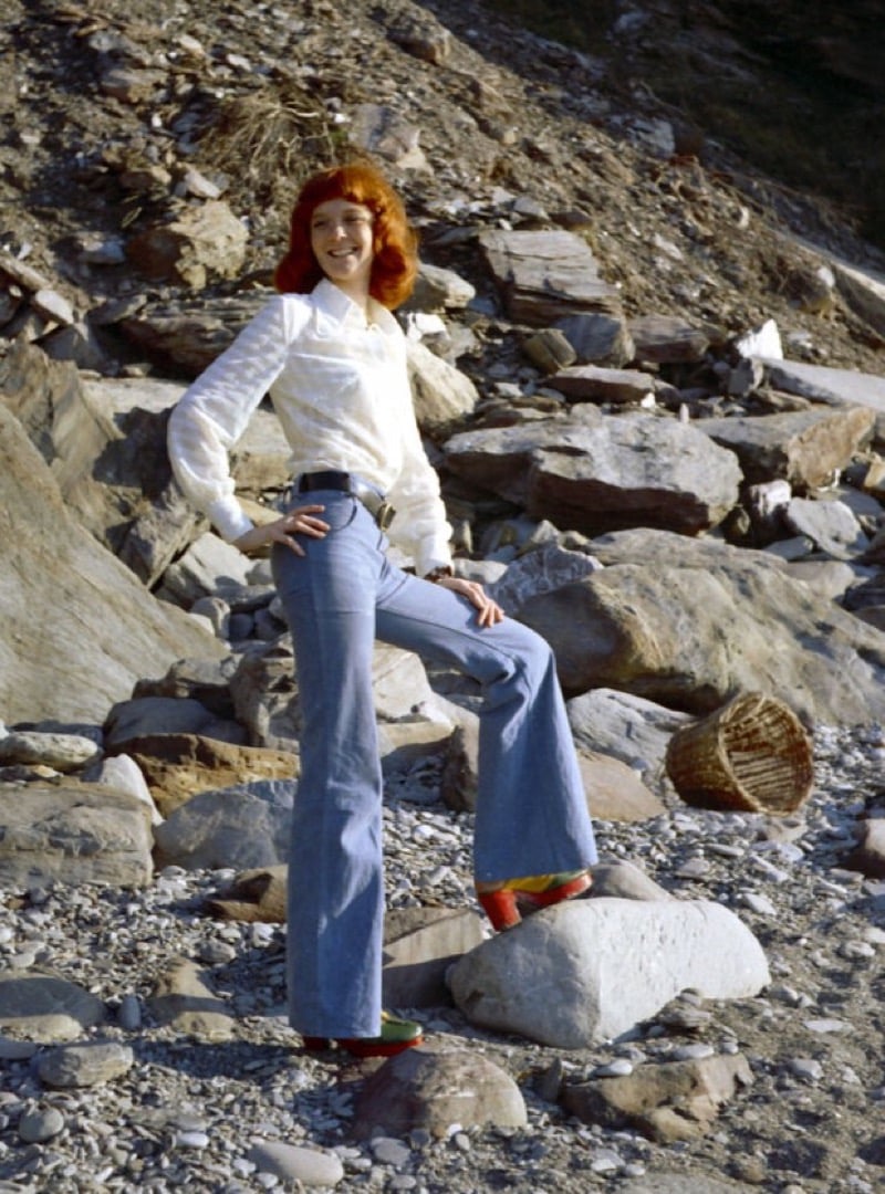 Woman in bell bottoms and platform shoes on a 1970s beach