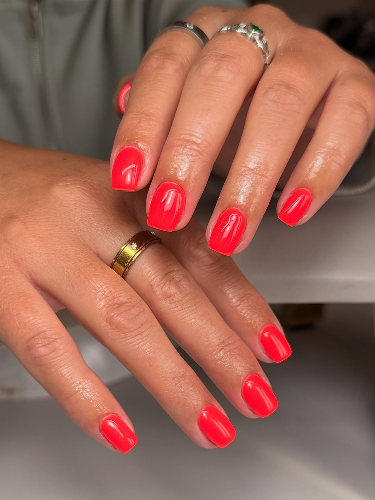 Bright coral manicure on short round nails