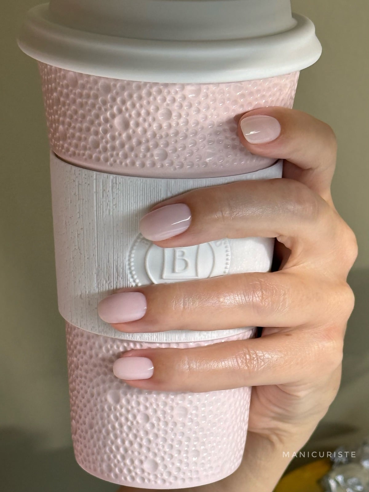 Milky sheer coconut-colored manicure on short round nails